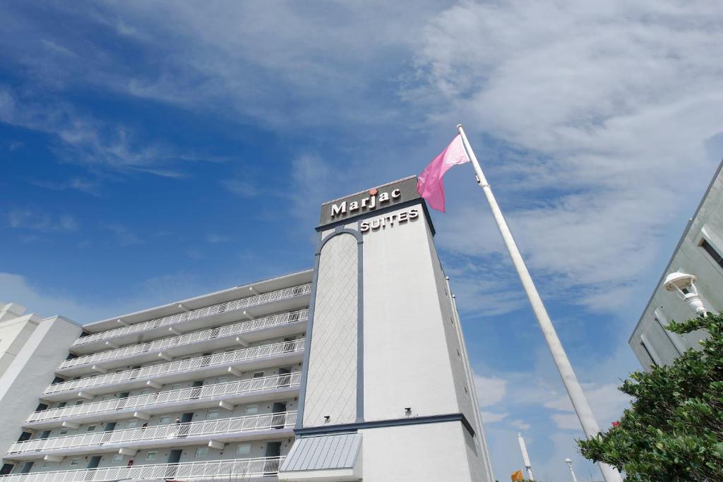 弗吉尼亚海滩弗吉尼亚海滩海滨马尔杰克套房酒店的大楼顶部有旗帜的酒店
