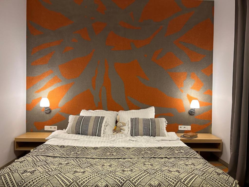 TomiceHotel Eldorado的一间卧室配有一张带橙色墙壁的大床