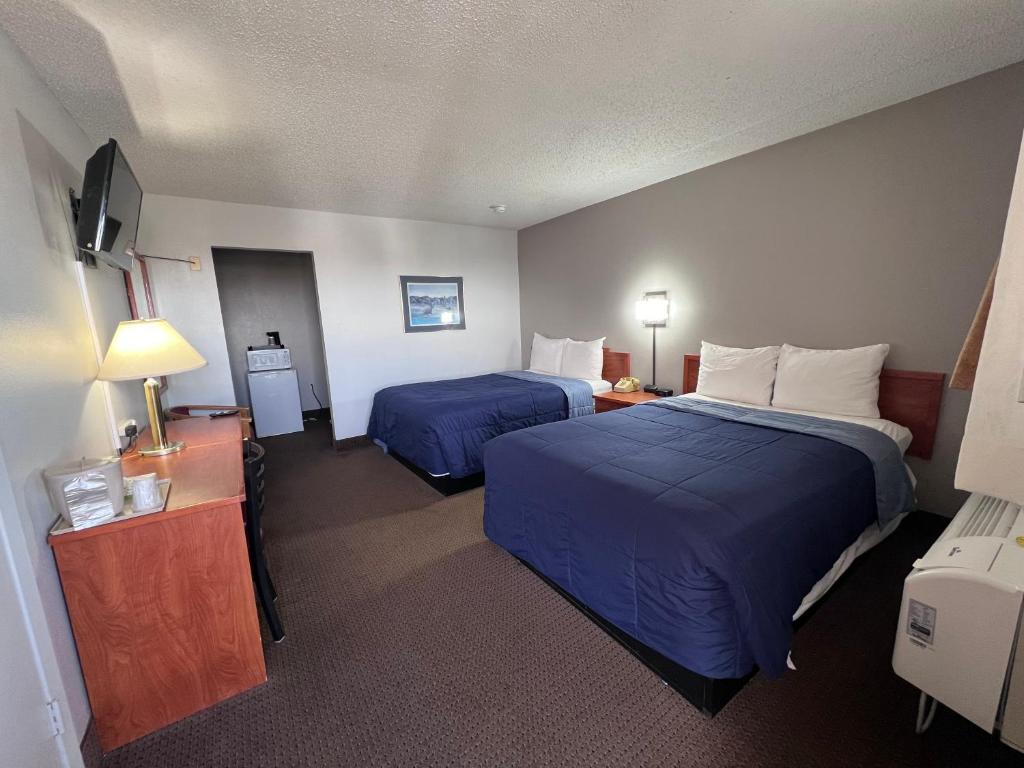 道奇城Regency Inn的酒店客房设有两张床和电视。