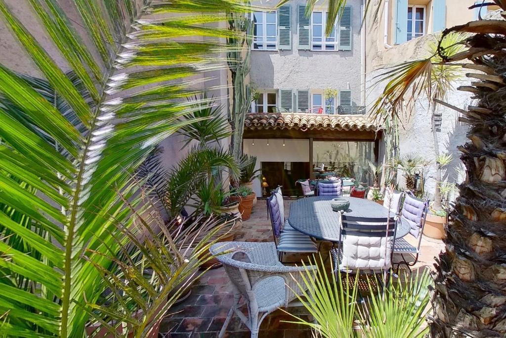 格里莫王子住宿加早餐旅馆的一个带桌椅和棕榈树的庭院