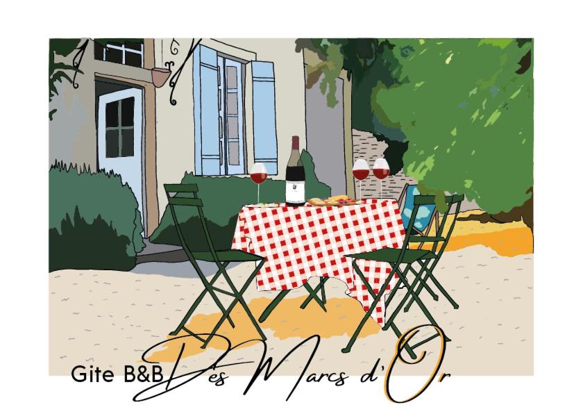 第戎马尔克斯奥罗住宿加早餐旅馆的一张桌子、两把椅子和一瓶葡萄酒