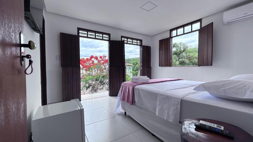 伦索伊斯Pousada Estrelar的一间卧室设有一张床和一个美景窗户。