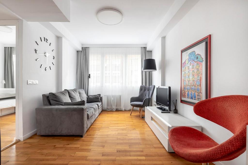 巴塞罗那拉梅尔佐那德巴塞罗那公寓的客厅配有沙发和墙上的时钟