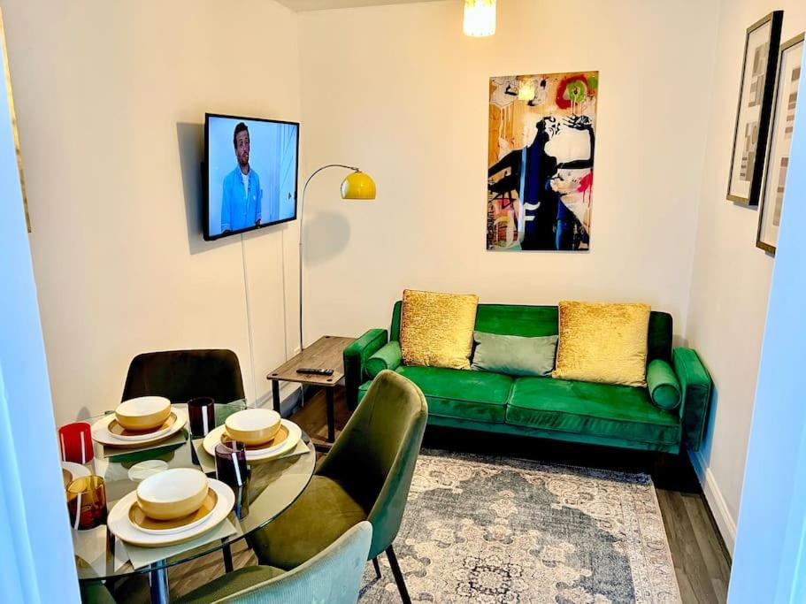 伦敦Affordable 2 bedroom flat Tower Bridge/Bermondsey的客厅配有绿色沙发和桌子
