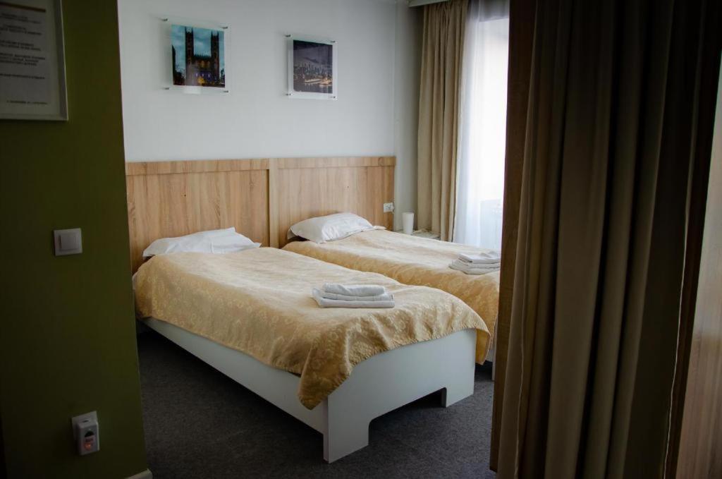 卡拉甘达Tumar Apart Hotel的一间卧室设有两张床和窗户。