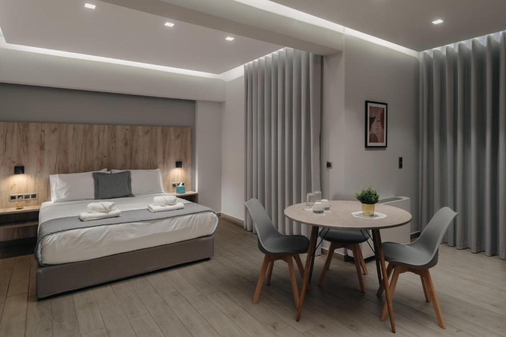 里奥Vialmar Premium Apartments的卧室配有一张床和一张桌子及椅子