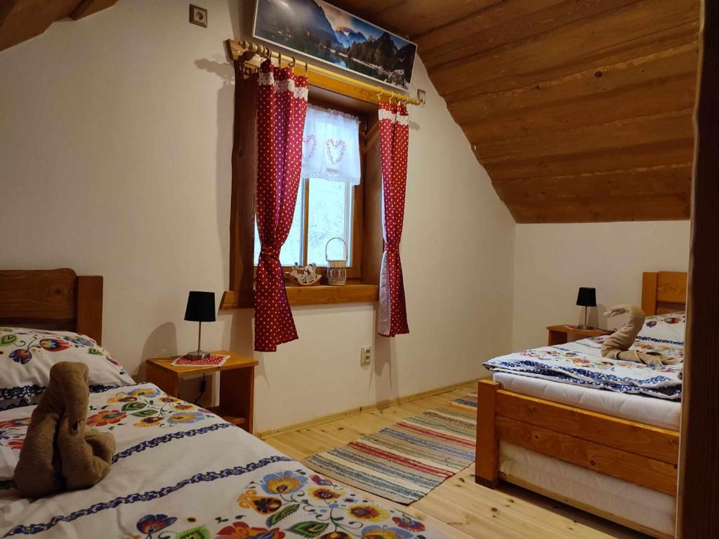 HaligovceDolná chata u Bratríkov的一间卧室设有两张床和窗户。