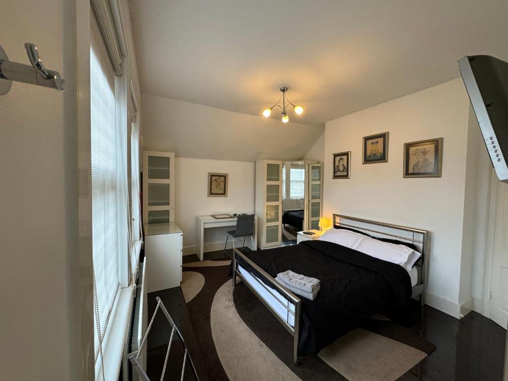伦敦Luxury Cottage Room的一间卧室配有一张床和一张书桌