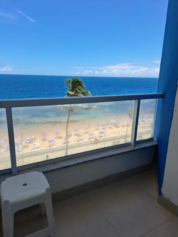 萨尔瓦多Bahia Flat 301的阳台享有海滩美景,配有椅子。