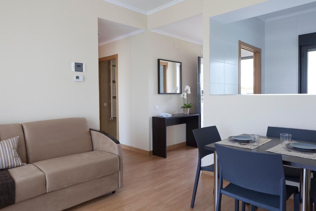 维多利亚-加斯特伊兹怡和阿里斯蒂公寓式酒店的客厅配有沙发和桌子