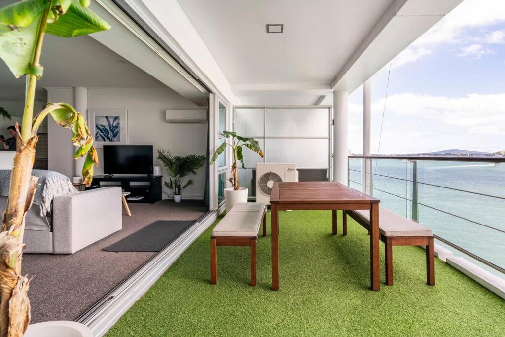 奥克兰Luxury Apartment With Stunning Harbour & City View的客厅配有桌子,享有海景