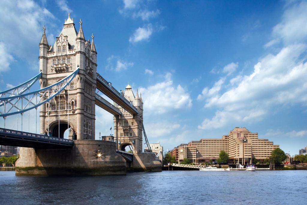 伦敦The Tower Hotel, London的一座水面上的桥梁,建筑背景