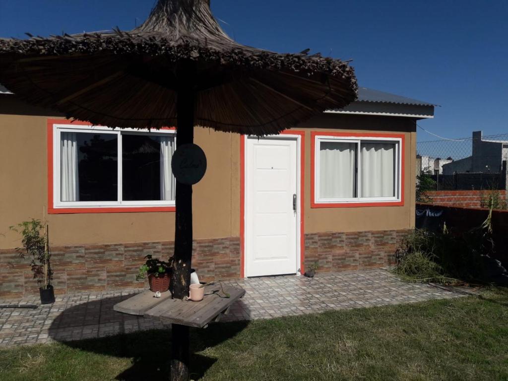 GualeguaychúLa Delia的一座带白色门和遮阳伞的房子