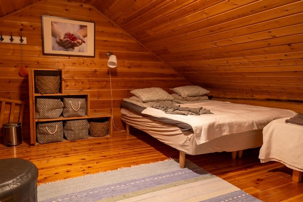 罗瓦涅米Kotatuli Forest Lodge的小木屋内一间卧室,配有一张床