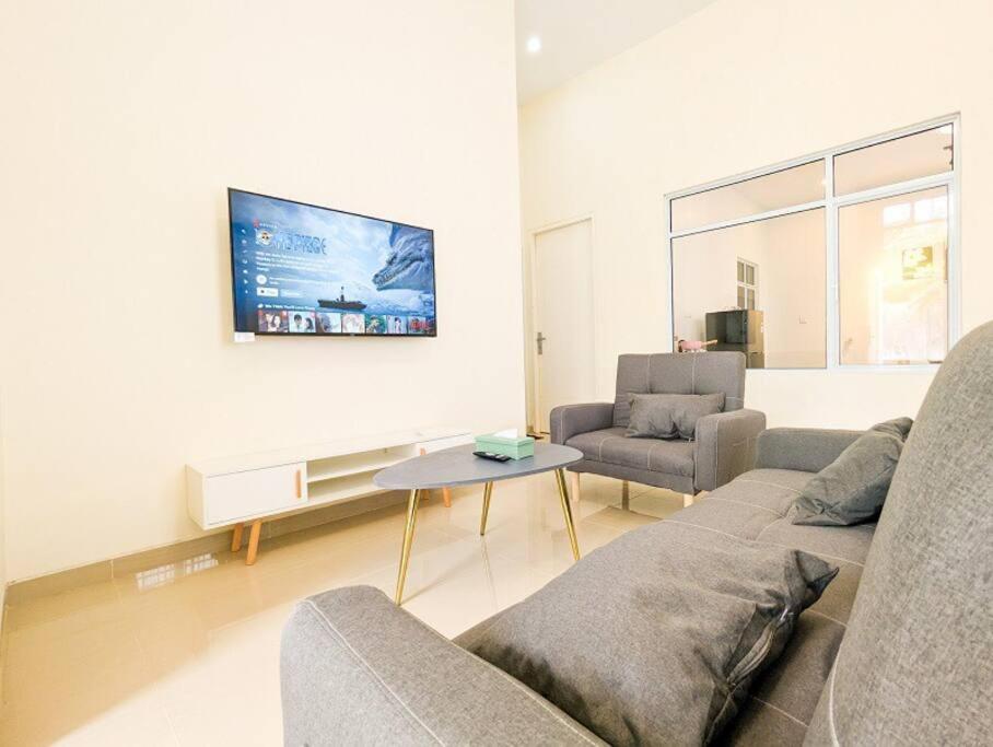 巴淡岛中心Lovina B2/12A at Ansley Park Spacious+Netflix的客厅配有沙发和桌子