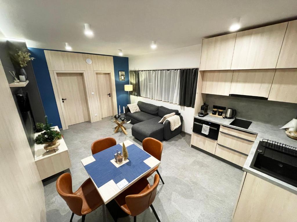 鲁容贝罗克Apartmán A2 - Hrabovo的厨房以及带桌子和沙发的客厅。