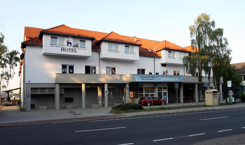 伊尔梅瑙伊尔梅瑙霍夫酒店的一条白色的大建筑,街道上的酒店