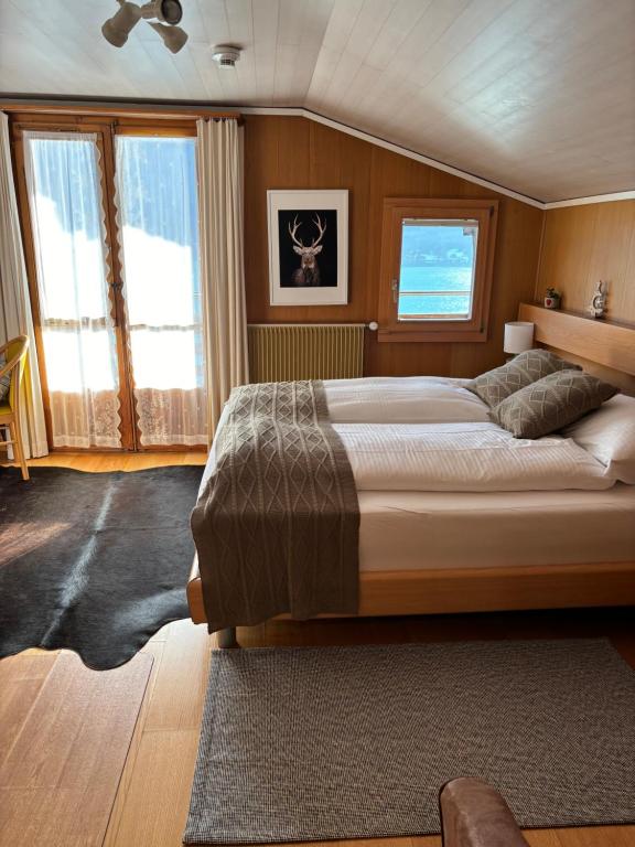 林根贝格Alpina Boutique Hotel Ringgenberg的一间卧室设有一张大床和窗户。