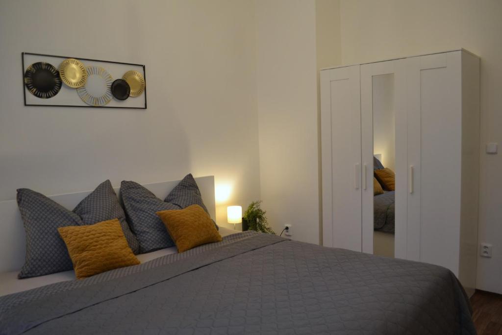 波杰布拉迪Apartmán u Fontány的一间卧室配有一张带黄色枕头的灰色床。