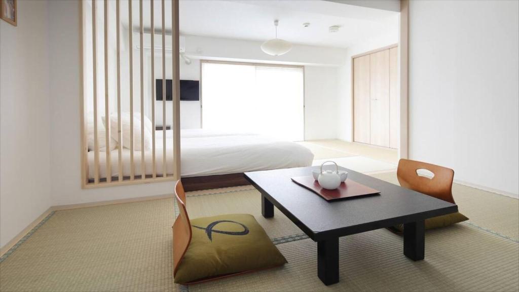 京都Kyoto - Hotel / Vacation STAY 73651的配有桌椅和床的房间