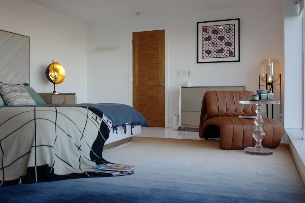 洛杉矶Skyline Serenity Luxe Suite-Private Room的一间卧室配有一张床、一张沙发和一把椅子