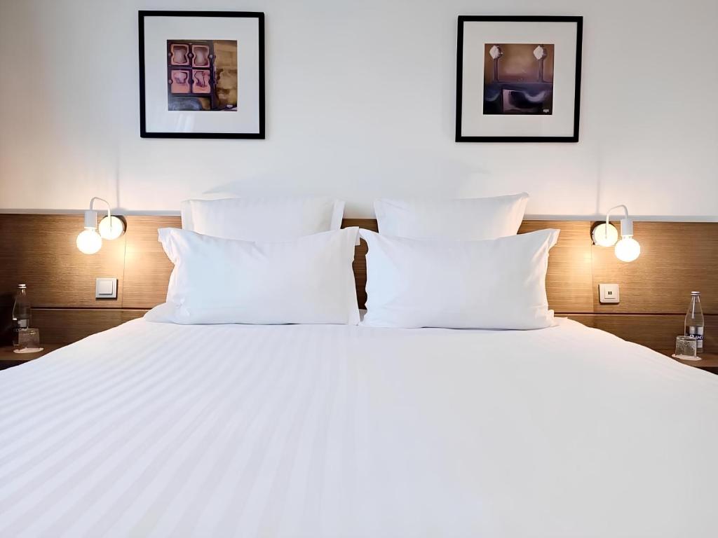 盖朗德城市 & Spa 贝斯特韦斯特酒店的卧室配有带白色枕头的大床