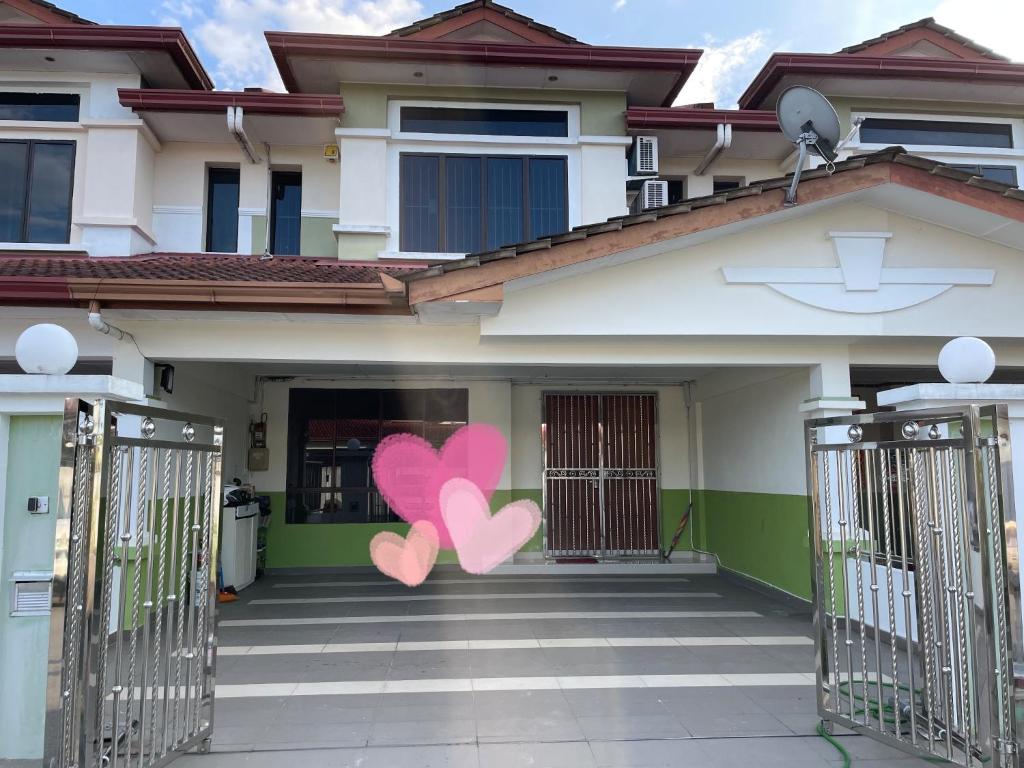 诗巫Sibu Homestay Happy Family的两颗粉红色的心画在上面的房子
