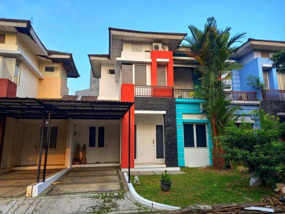 CibuntuHouse in Grand Wisata Bekasi的前面一排种着棕榈树的房屋