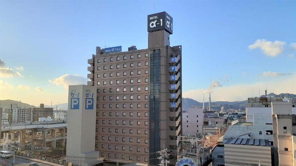 周南市Hotel Alpha-One Tokuyama的一座高大的建筑,上面有一个钟楼