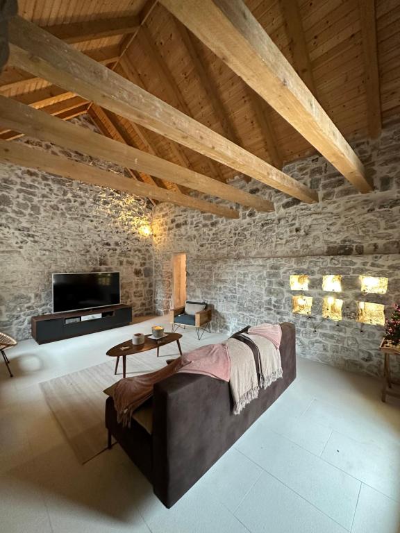 加塔Maison Laurel - Exquisitely Renovated Centuries Old Stone Estate With Private Pool, Near Split and Omiš的带沙发和电视的客厅