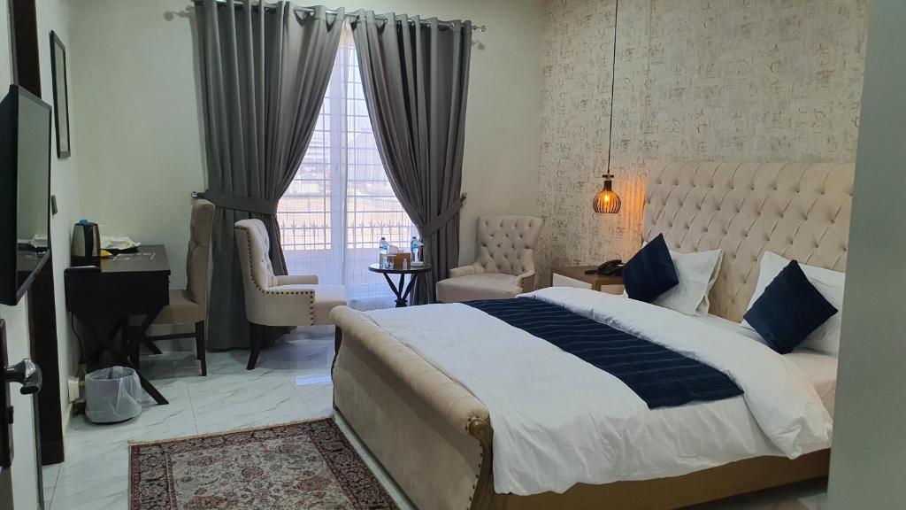 伊斯兰堡Bloom Rooms的一间卧室设有一张大床和一个窗户。