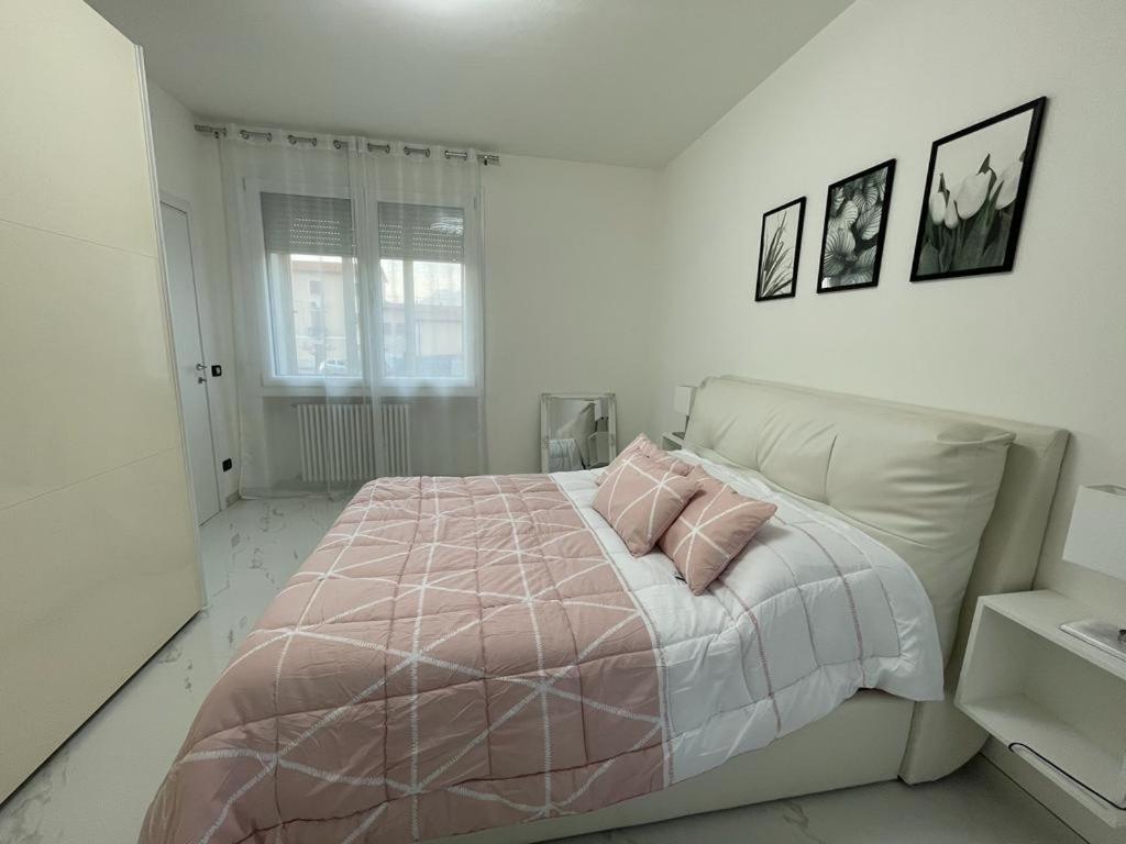 蒂耶内Casa M&N的白色卧室配有带2个粉红色枕头的床