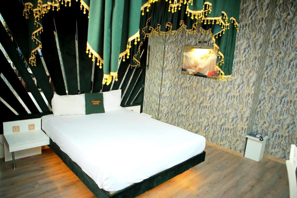巴库Titanik Hotel的卧室配有一张带蜡烛的白色床