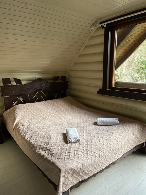 米戈韦Goral cottage in Migovo的一间卧室配有一张床,上面有两条毛巾
