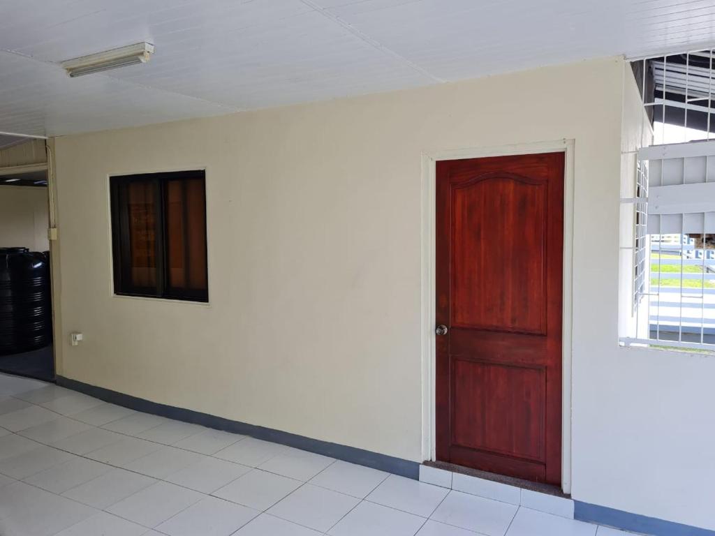 帕拉马里博THE NICHE STUDIO的一间红色门和白色墙壁的房间