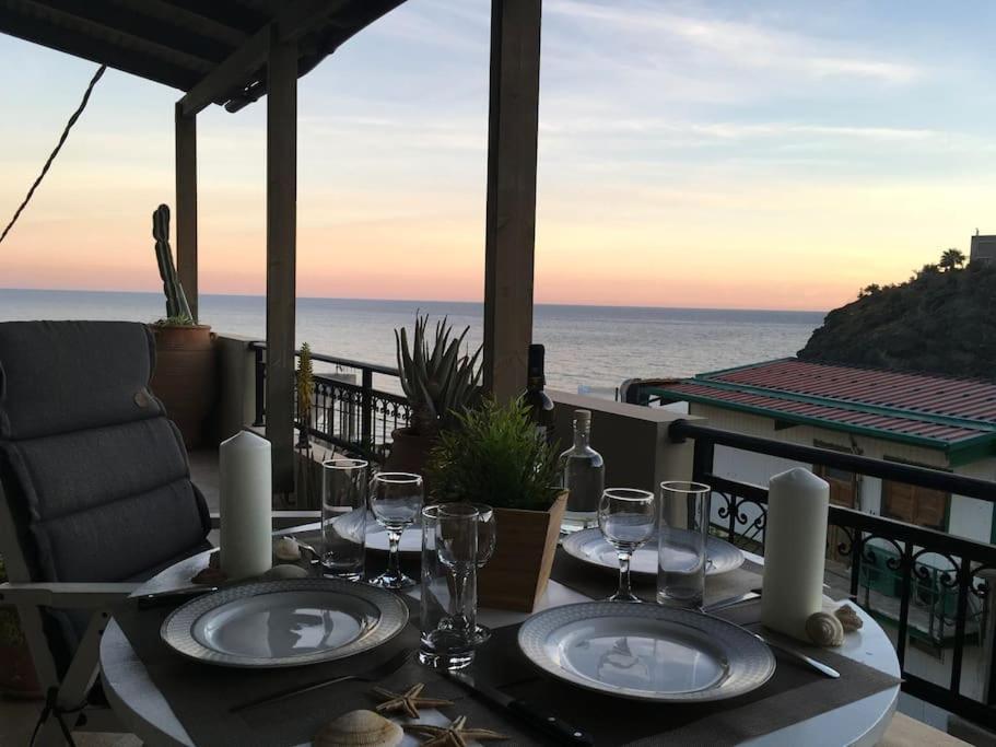 ParánimfoiAmazing Beachside Apartment With Panoramic Seaview的一张桌子和酒杯,享有海景
