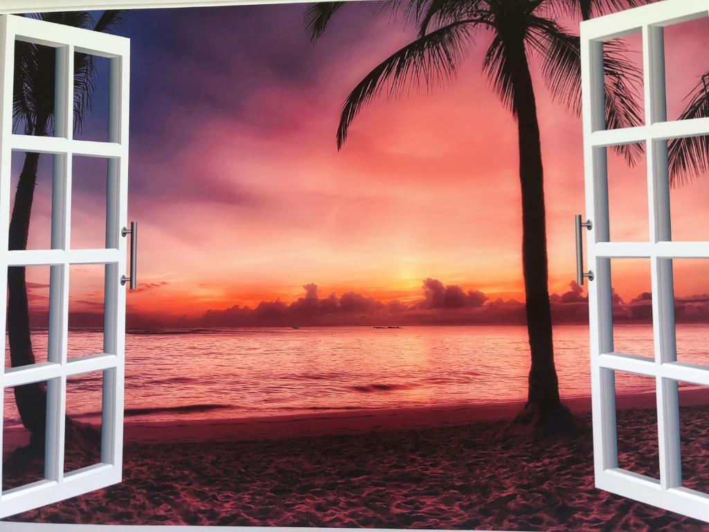 读谷村senahahausub03的享有日落美景的热带海滩的开放式窗户