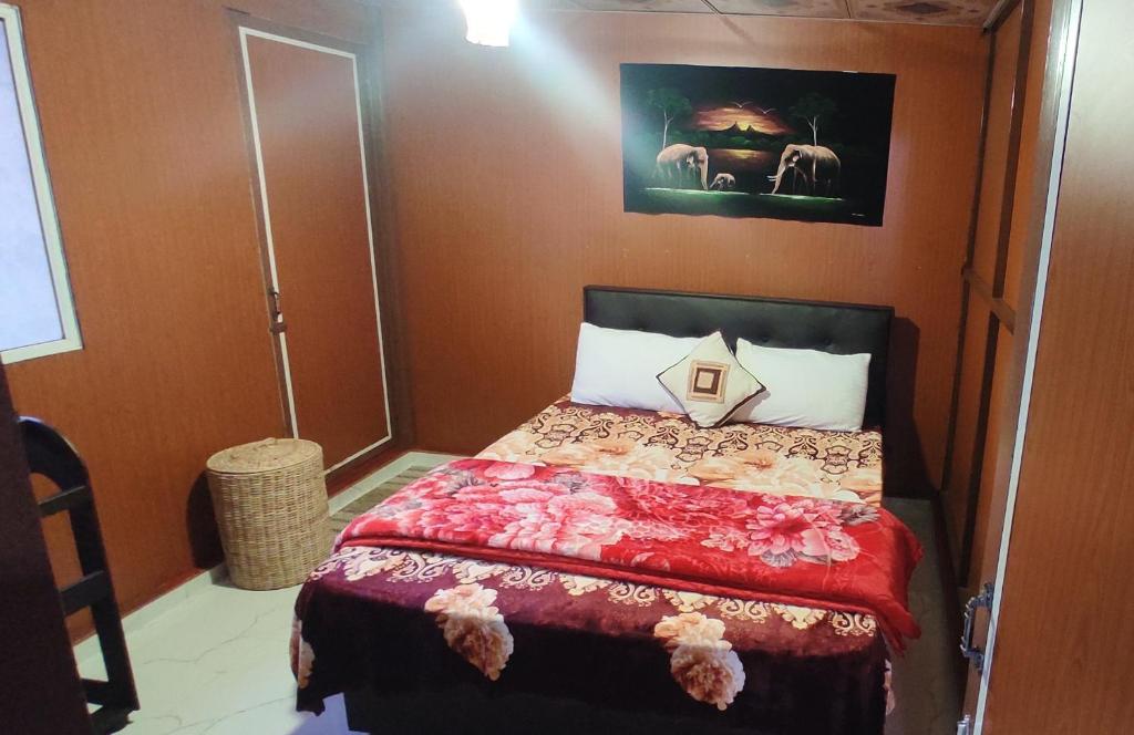 努沃勒埃利耶Townside Lodge的一间卧室配有一张红色棉被的床