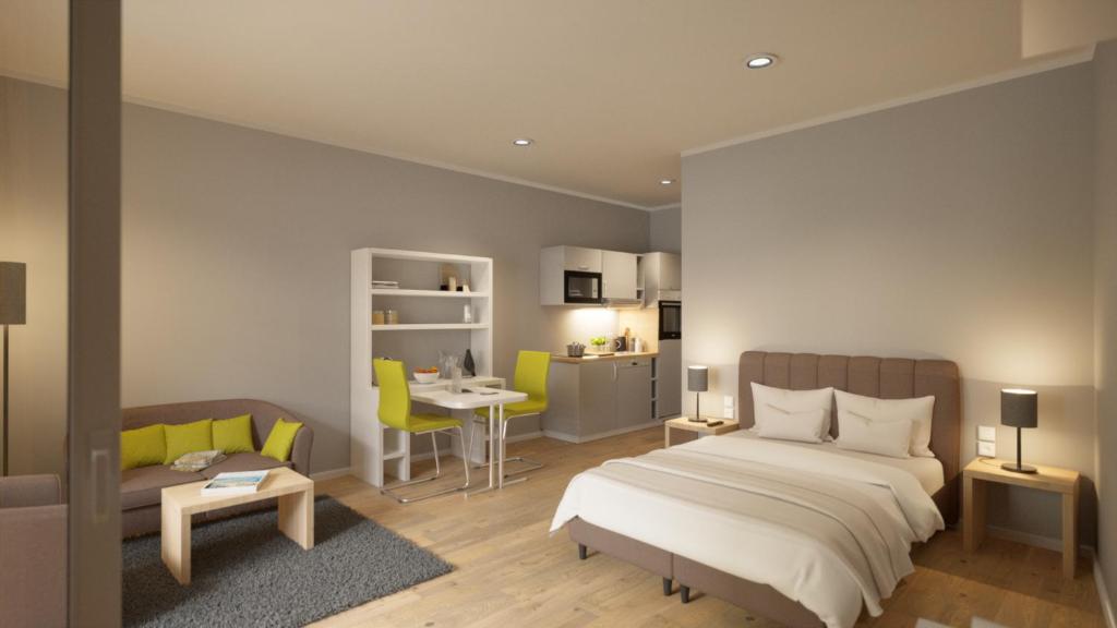 韦茨拉尔Adapt Apartments Wetzlar的一间卧室配有一张床、一张沙发和一张桌子