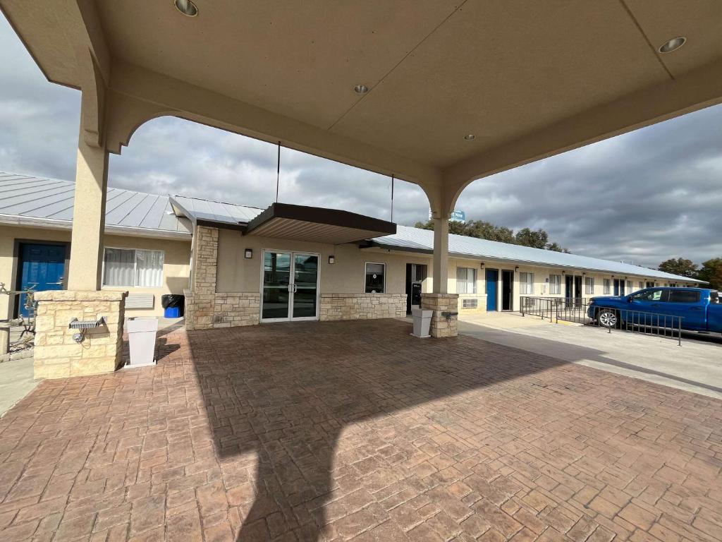 章克申Motel 6 Junction, TX Llano River的一座大型建筑,前面有停车位