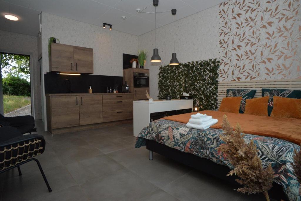 马尔梅迪Au Vieux Chêne的一间带大床的卧室和一间厨房