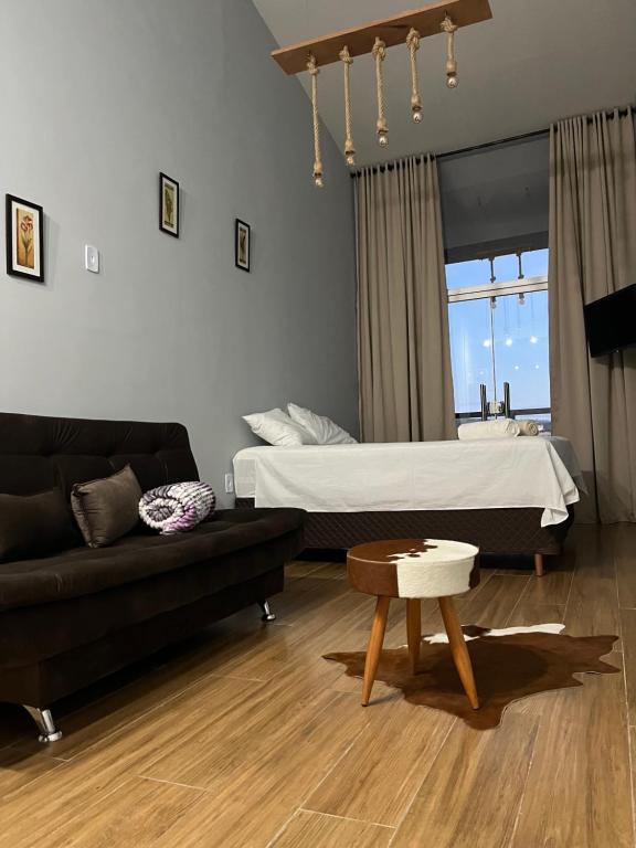 瓦拉达里斯州长市Skyloft Chalé的客厅配有床和沙发