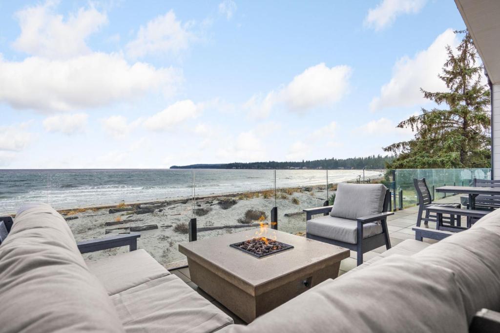 坎贝尔河Beachfront Luxury Suite #19 at THE BEACH HOUSE的一间带沙发和海滩火坑的客厅