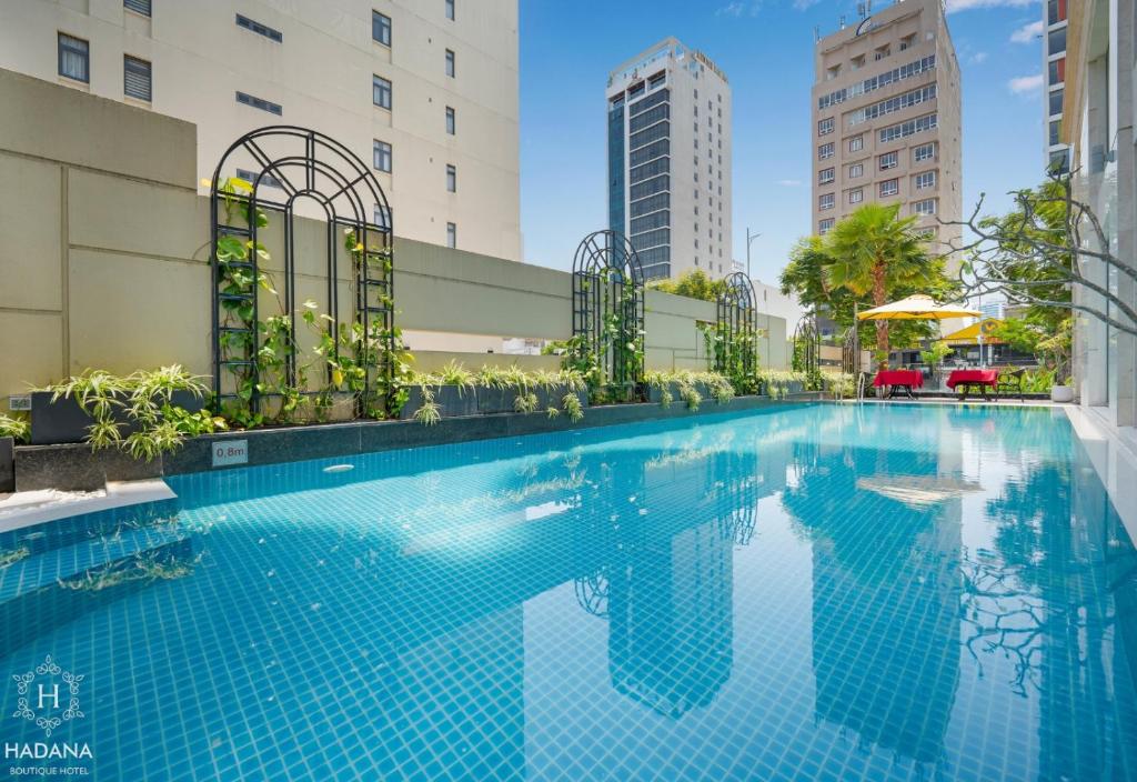 岘港Hadana Boutique Hotel的一座高楼内的游泳池