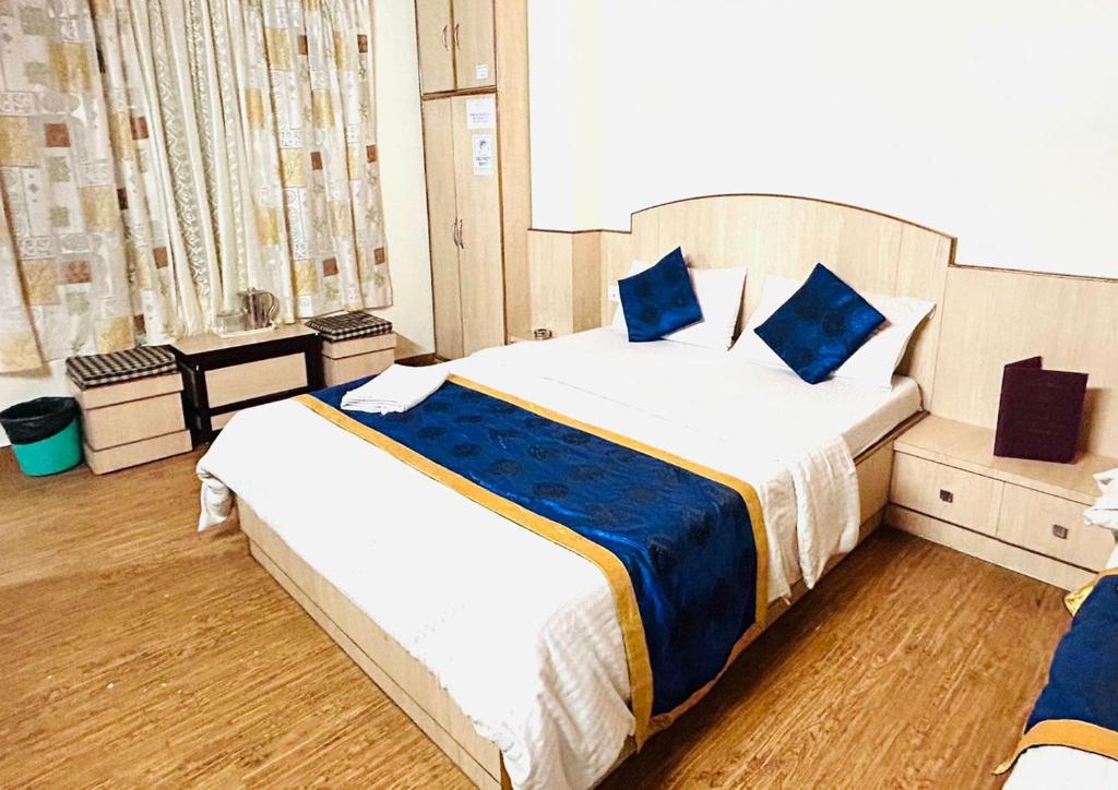 甘托克Dhe Kyi Khang by Magwave Hotels-100 Mts from MG Marg的一间卧室配有两张带蓝色枕头的床