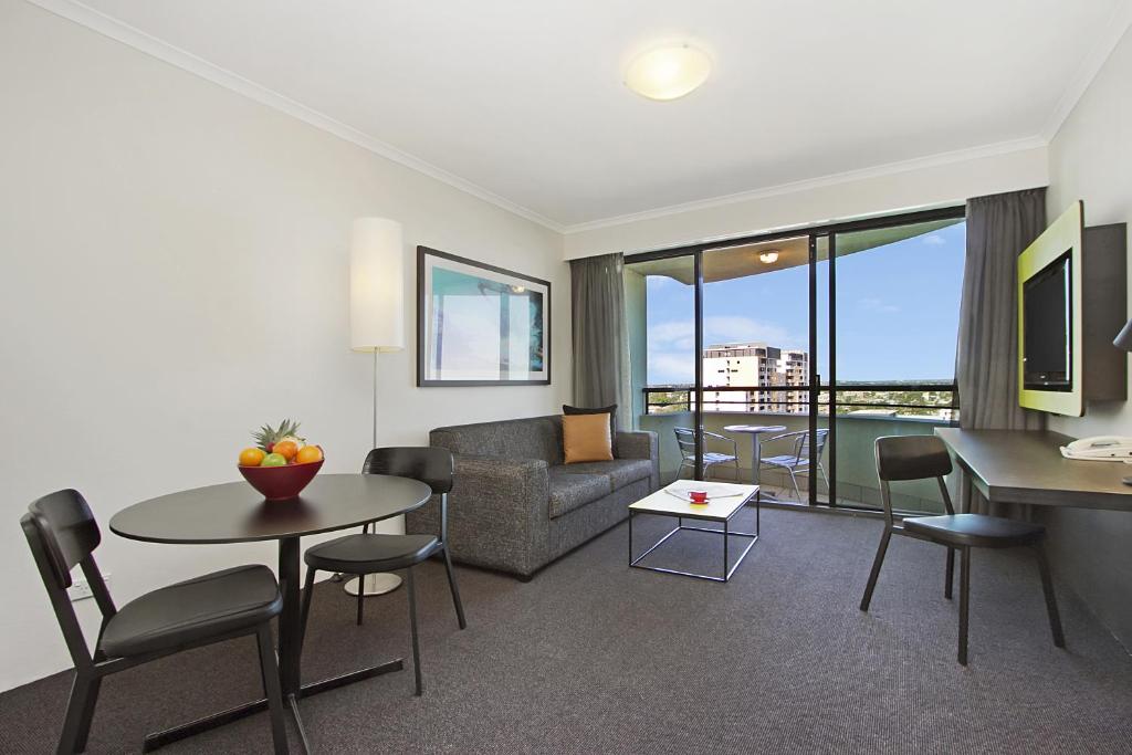 悉尼曼特拉帕拉马塔酒店的客厅配有沙发和桌子