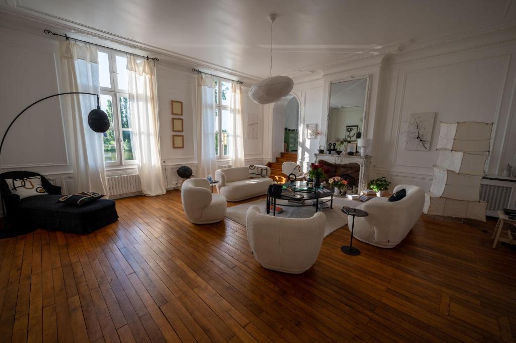 阿姆博斯MAISON HULOTTE的大型客厅配有白色家具和木地板