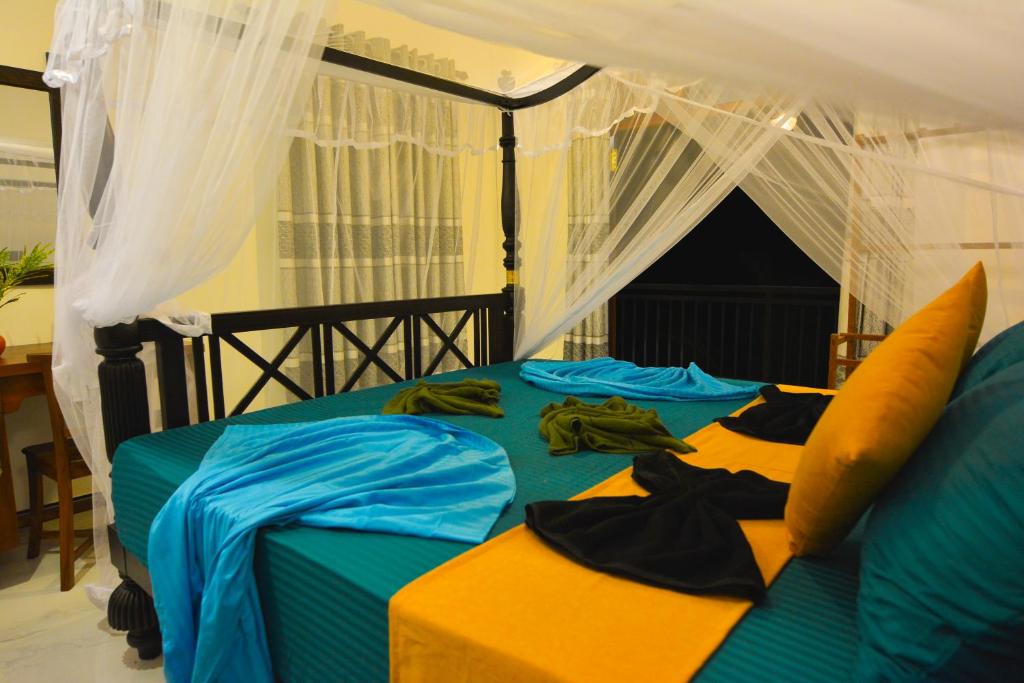 希克杜沃Monkey Island Hotel的一间卧室配有一张带天蓬的床