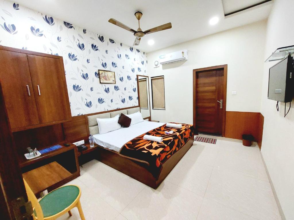 马图拉HOTEL BABYLON REGENCY, Opp Krishna Janmabhoomi Temple的一间卧室配有一张床和一台电视。
