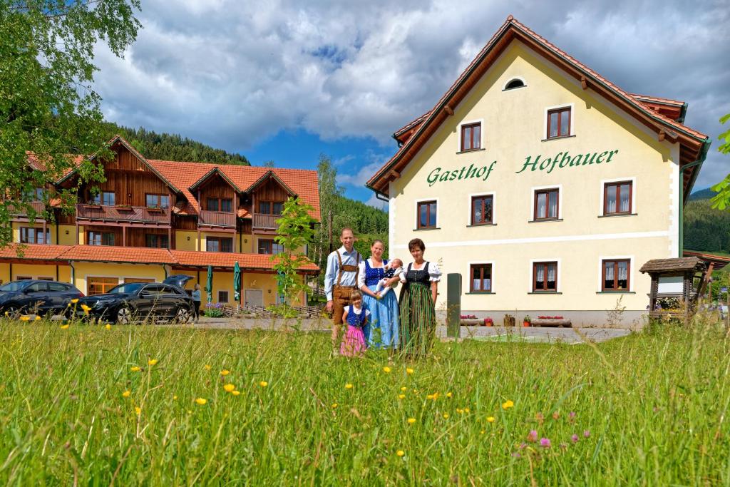 Breitenau am Hochlantsch霍夫鲍尔宾馆的一群站在建筑前方的田野上的人